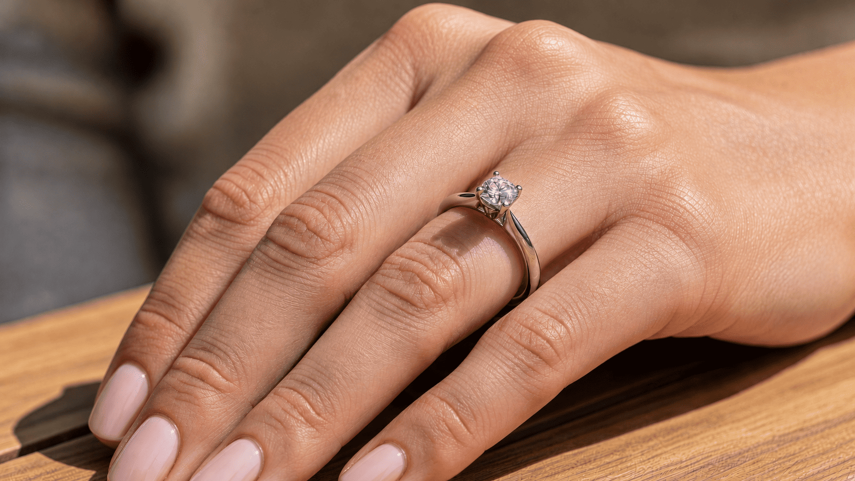 close up of diamond engagement ring on hand